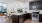 Quartz countertops and dark cabinets in apartment kitchen