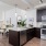 Quartz countertops and dark cabinets in apartment kitchen