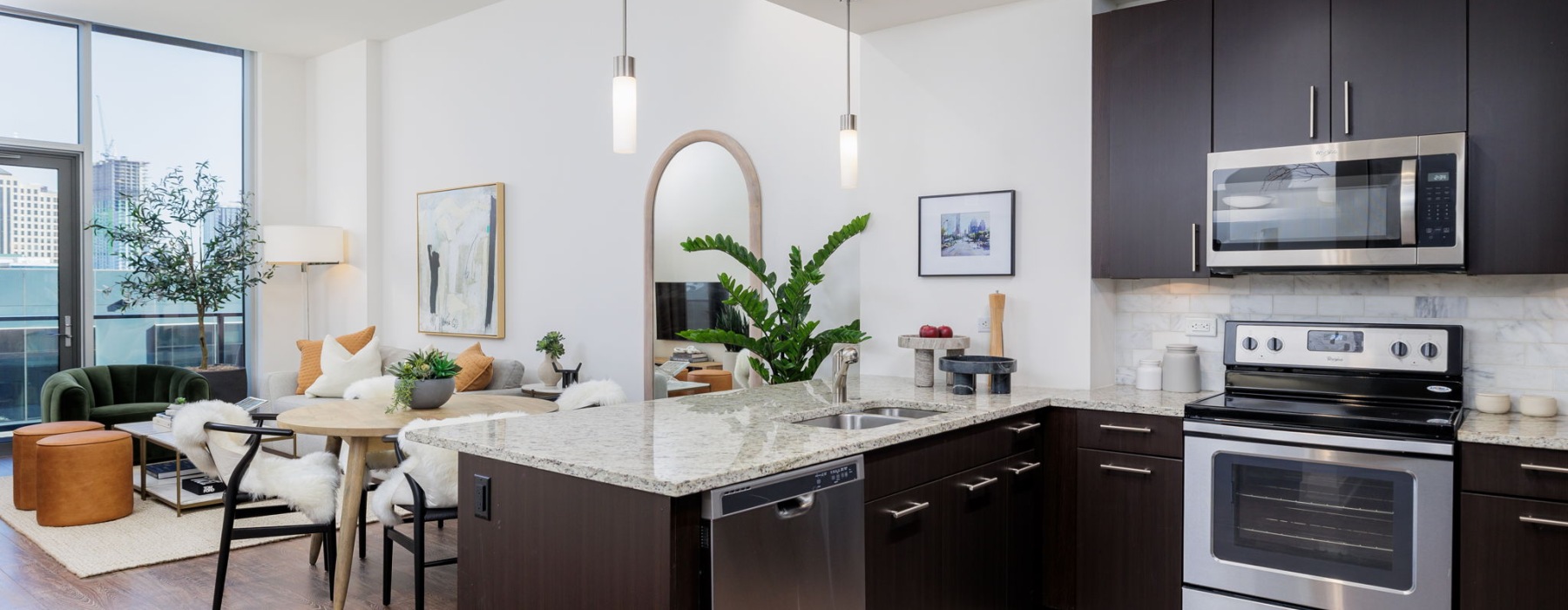 Quartz countertops and dark cabinets in apartment kitchen