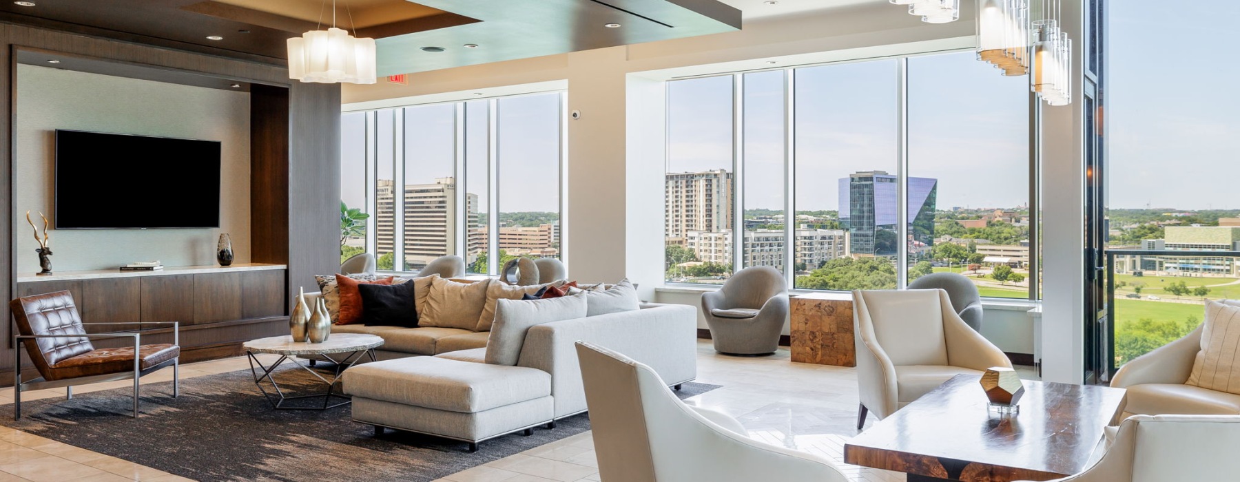 Resident lounge with couches and chairs overlooking Lady Bird Lake in Austin Texas