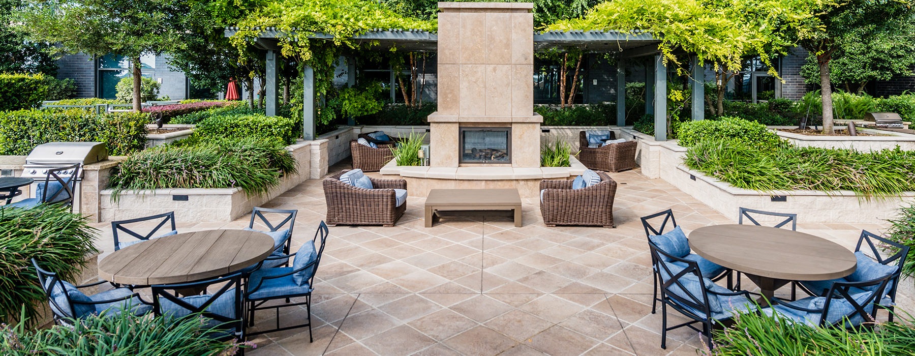 Large outdoor fireplace surrounded by the pool and plenty of seating 