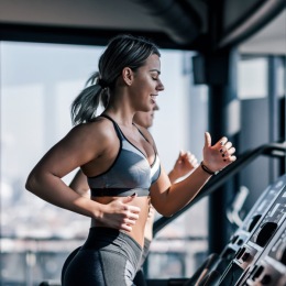 a woman running on a treadmill